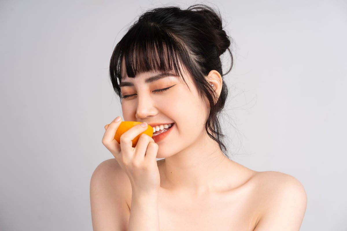 Young Asian Woman Skincare with Orange